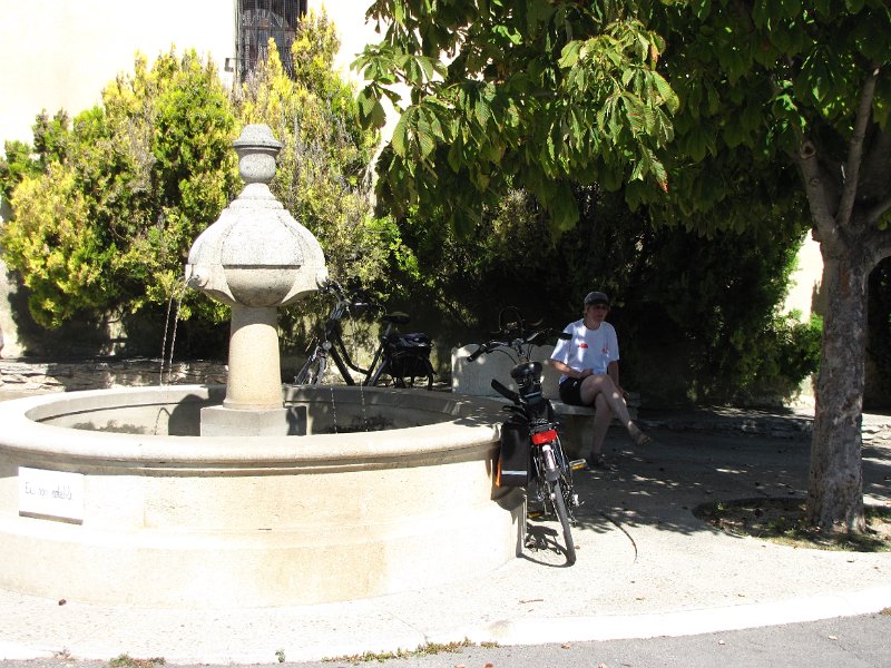 frouwkje op dorpsplein blauvac.jpg - Even uitrusten op het dorpsplein van Blauvac. Erg aardig in deze streek: elk dorp heeft een drinkwater aansluiting op het dorpsplein. Erg prettig in een streek waar de temperatuur aardig kan oplopen.